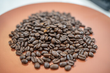 Fresh organic raw coffee beans on a plate