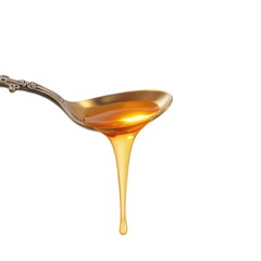 Honey dripping from ornate silver spoon studio setting close-up shot