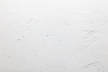 A white wall with a rough texture