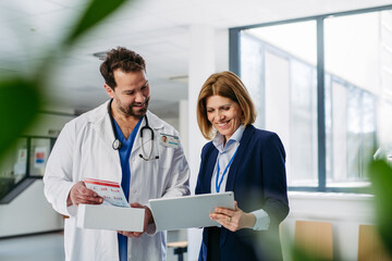 Female medical sales representative presenting medication to doctor
