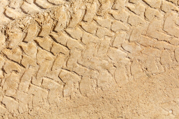 The tire tracks are in the sand, and they are very deep