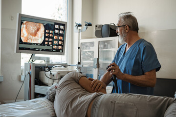 Gastroscopy procedure on sedated patient to examine upper digestive tract.