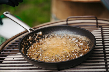 Melting brown sugar and butter in pan for dessert.