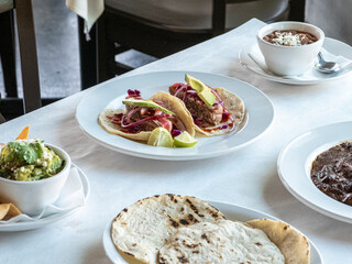 Tacos and Mexican food spread on table