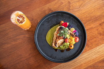 Overhead view of round plate with chicken dish