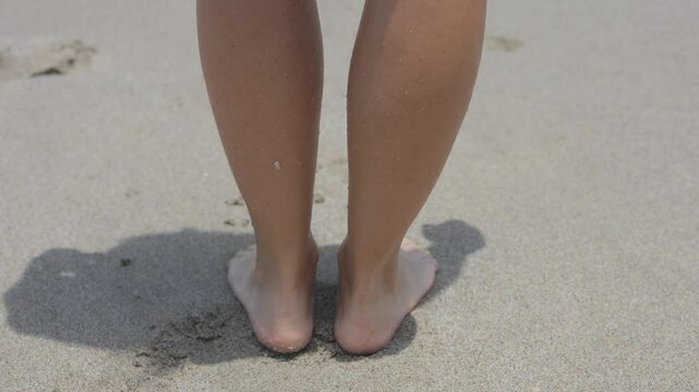 Women girl walkaway on sand beach to ocean sea water with rolling waves on heels and feets