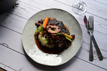 The rich sauce and slow-cooked ingredients highlight a traditional comfort food dish, ideal for showcasing homemade gourmet meals or autumn and winter recipes.