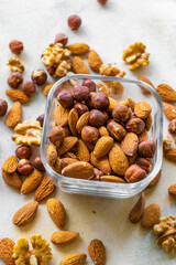 Mix of nuts, walnuts, hazelnuts, almonds in a beautiful glass dish, view from above