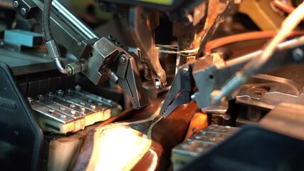 a craftsman handmade a shoe by a machine, close up shot, insert shot