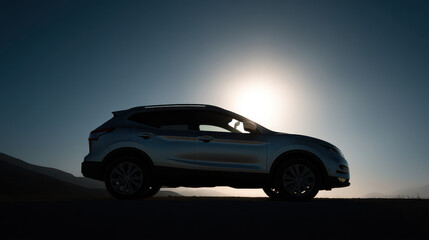 Obraz premium sleek suv parked against stunning sunset backdrop