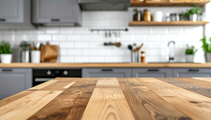 A modern kitchen featuring a wooden countertop, gray cabinets, and open shelving with various kitchenware and plants, creating a warm and inviting atmosphere