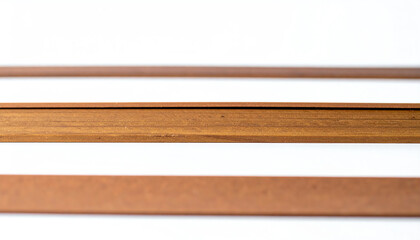Wooden strips arranged parallel on a white surface, highlighting texture and color variations in a minimalist composition