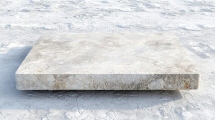 A white marble slab with a rough texture and a slightly raised edge sits on a snowy surface.