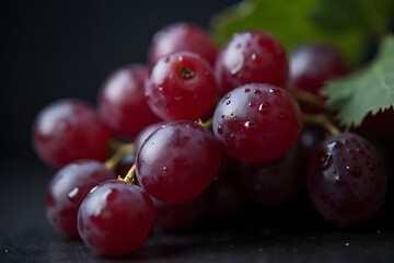 Fototapeta premium Close up view of fresh red grapes with water droplets against a dark background