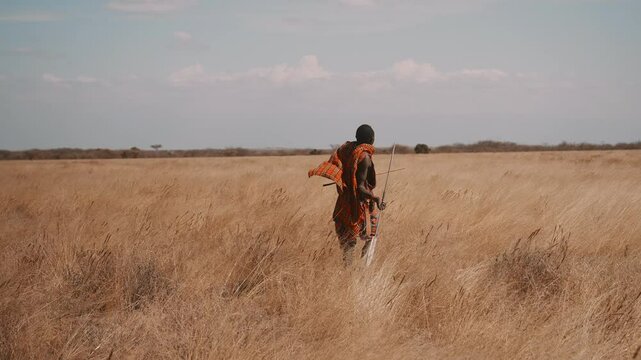Masai Warrior Throwing Spear in African Savannah