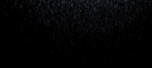 Rain overlay on black background, falling raindrops, blurred water droplets, rainy scene, cinematic rainfall texture, wet weather effect, stormy atmosphere