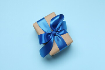 Beautiful gift box on blue background, top view