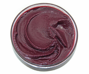 BOWL OF ACAI CREAM AMAZON FRUIT ON ISOLATED WHITE BACKGROUND