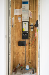 Water and electrical meter on a meter cupboard in a modern, gas-free, energy efficient home.