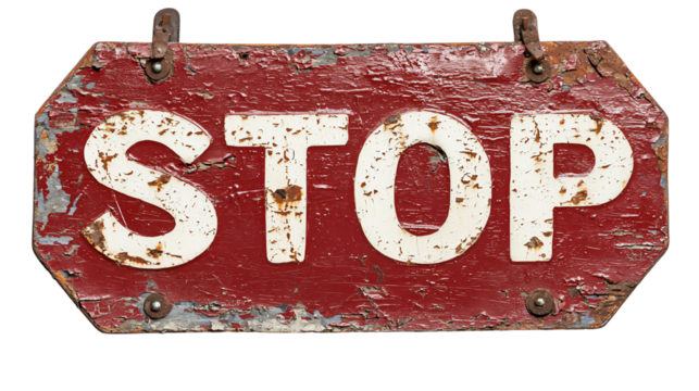 Vintage weathered stop sign with white letters on a red background.