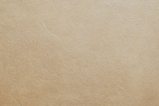Light beige, smooth, textured surface.  Close-up view of a light beige material. Subtle, fine lines and slight variations in tone create a textured appearance