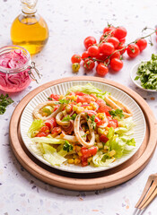 salad with squid, cucumbers, tomatoes and corn