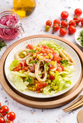 salad with squid, cucumbers, tomatoes and corn