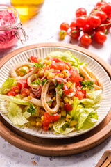 salad with squid, cucumbers, tomatoes and corn