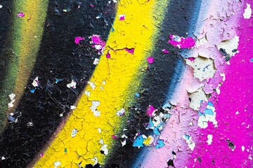 Graffiti texture in yellow, pink, blue with peeling paint. Urban 80s, grunge style, vibrant colors,...