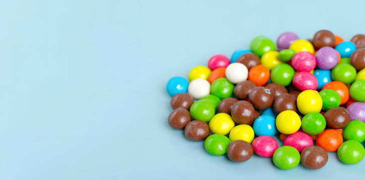 Pile of colorful chocolate coated candy isolated on white background