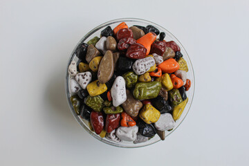 Turkish rocks chocolate, in a transparent bowl, isolated on white background, flat lay or top view
