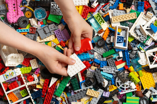 Illustrative editorial of Lego colorful assortment of plastic building blocks constructor in kid hands. Lego is a world famous company based in Billund, Denmark. KHARKIV, UKRAINE - 11 May 2025..