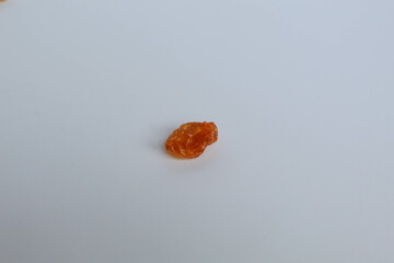 One piece of raisin on isolated white background