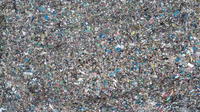 Top view of colorful plastic waste covering entire landfill site