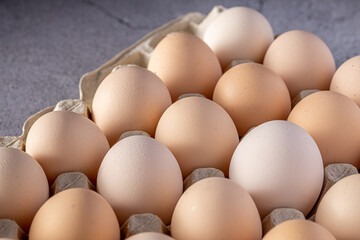 Brown eggs stacked in rows.Group of Fresh white Eggs in a cardboard cassette. Organic food from nature good for health.
