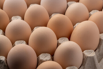 Brown eggs stacked in rows.Group of Fresh white Eggs in a cardboard cassette. Organic food from nature good for health.