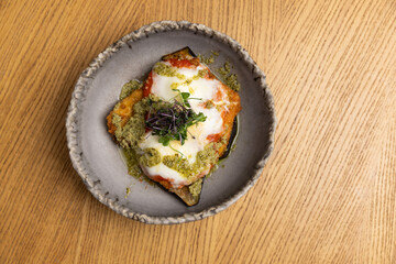 Top view of crispy chicken, rich vodka sauce and melty mozzarella cheese basil and pesto