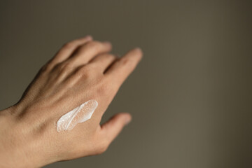 Female hand with moisturizing cream.
