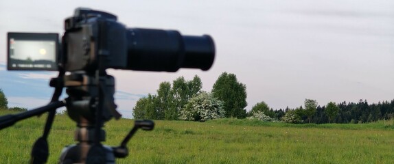 beautiful sunset with a field of grass and a small camera