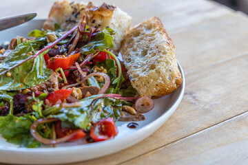 meat salad, bacon, egg, crouton, lettuce, salad dressing vinaigrette  saladcopy space food background rustic top view