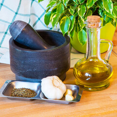 bottle of olive oil, mortar and pestle