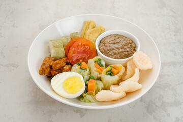 Gado Gado, Indonesian traditional vegetable salad with peanut sauce, rice cake, tofu, tempeh and egg
