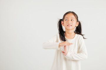 Closeup portrait young kid girl smiling making give time out gesture with hands studio shot...