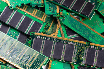 Computer memory modules stacked together on a green circuit board background