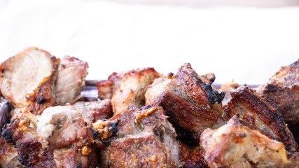 Grilled shashlik close-up on a light background, fried meat