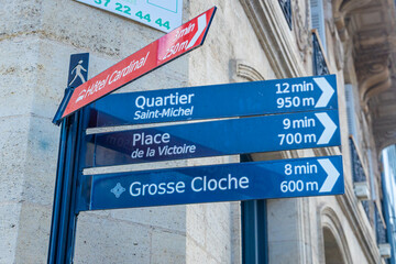 Signpost showing walking routes to the Saint-Michel district, Place de la Victoire and the Grosse Cloche in Bordeaux, France