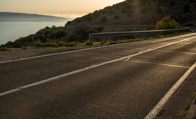 Curve of the coastal paved road located on a high cliff