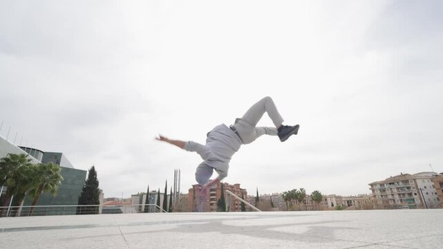 Breakdancer performing acrobatics in urban environment
