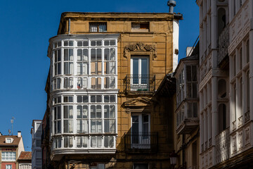 Fototapeta premium Sunlit Historic Building with Traditional Balconies and Stone Facade in Haro, La Rioja, Spain