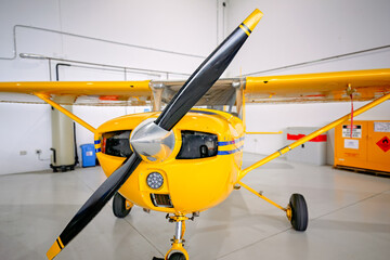 Yellow small plane airplane aeroplane, aircraft in hangar